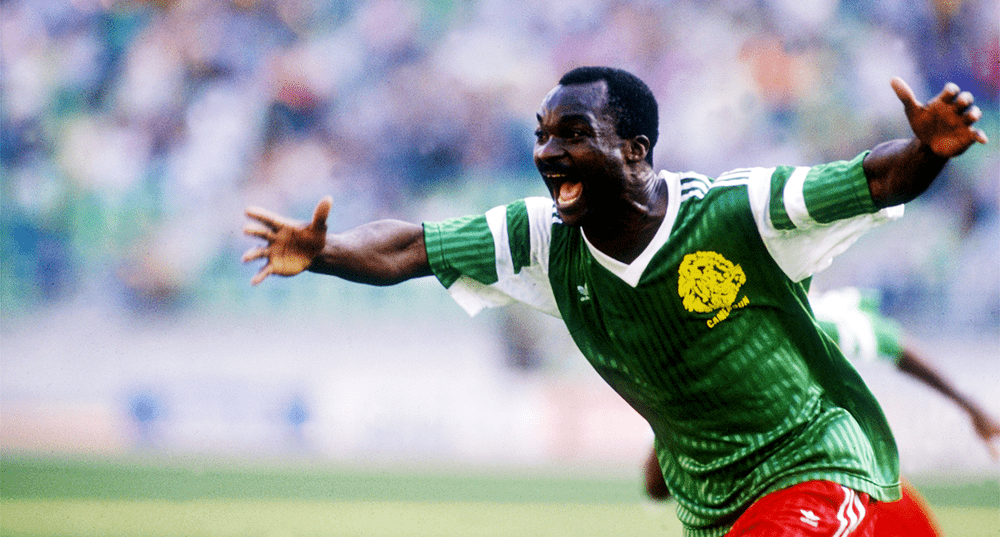 Maglietta Roger Milla By SpielRaum – Cotone 100%, 190 G/m², Morbida, Colori Blu, Beige, Bianco, Rosso, Taglie S-XXL